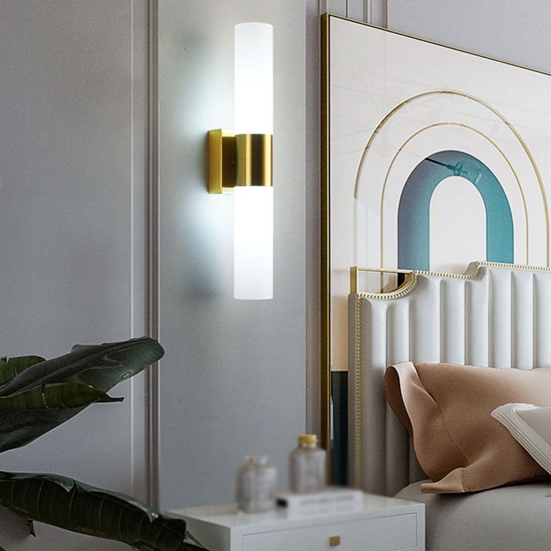 Leigh gold double-ended wall light beside a bed