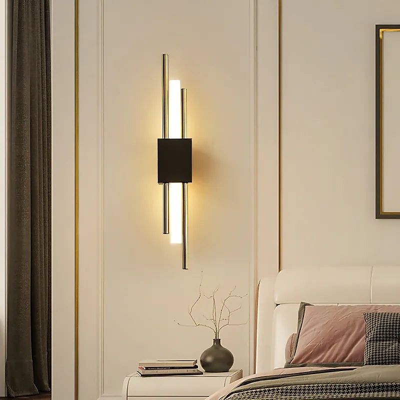 Gold-tone Alana light bars with a black centre in a bedroom setting