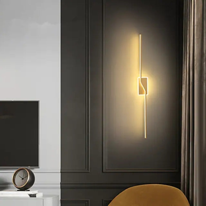 Gold-tone Nordic vertical bar light casting a wall glow
