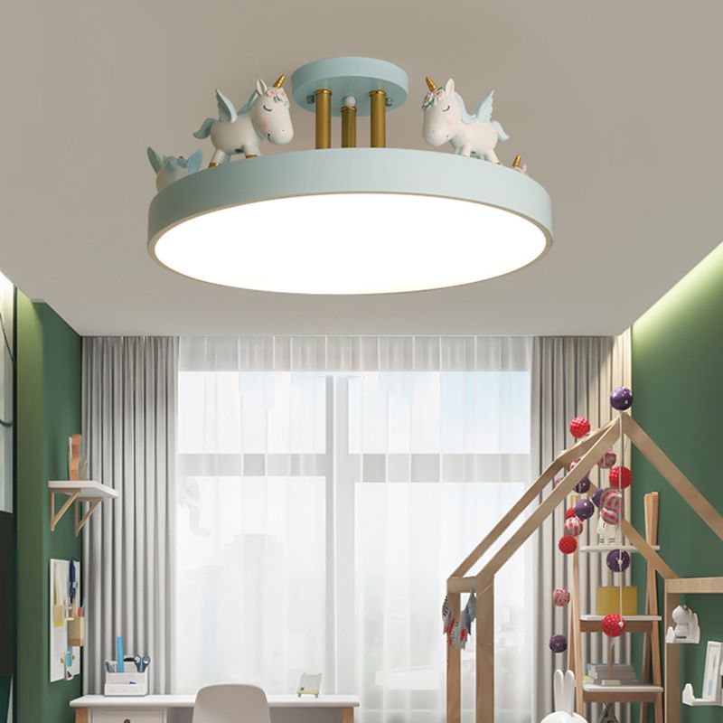 Blue unicorn ceiling light with gold-tone posts above a green room, desk and house-frame bed