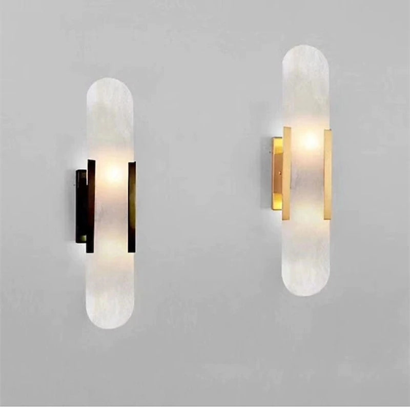 Black and gold Chan wall sconces displayed side by side