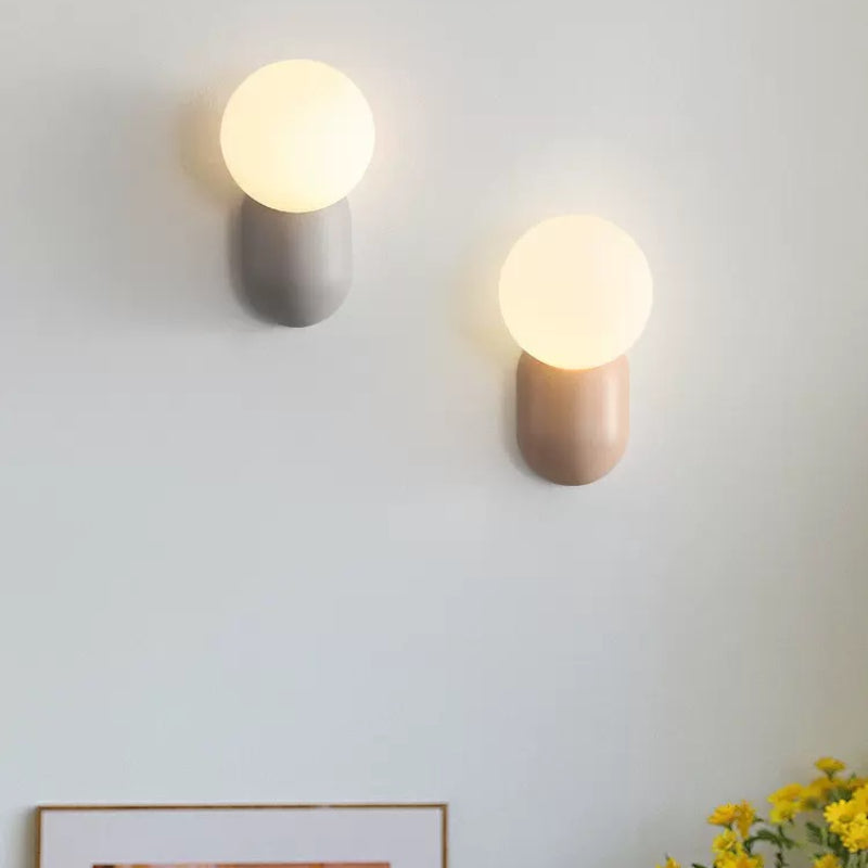 Grey and pink Hailie globe wall lamps displayed together
