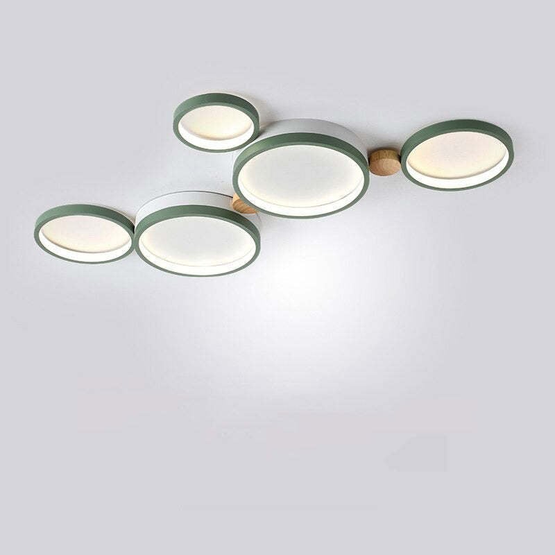 Green five-head ceiling light with round white light panels and wood details