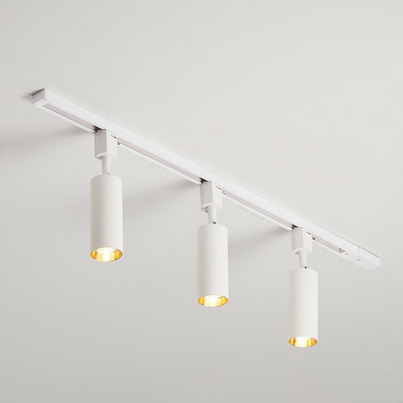 Large white three-head ceiling spotlight with longer cylinders and gold-tone light openings