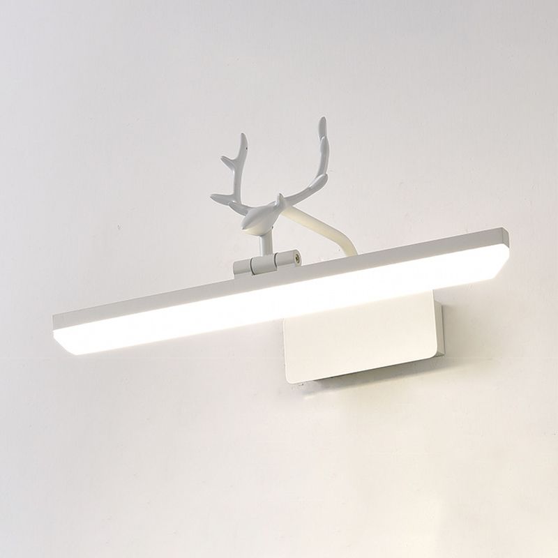 White antler wall light viewed at an angle against a pale wall, with a lit diffuser and rectangular mounting plate