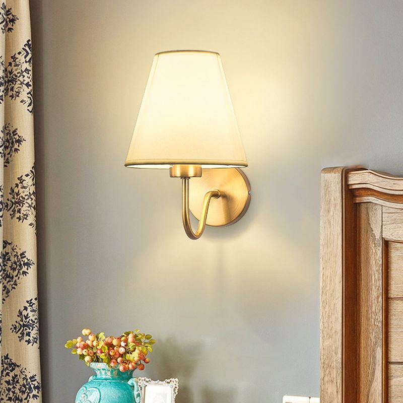 Eryn white fabric wall lamp above a console and flowers