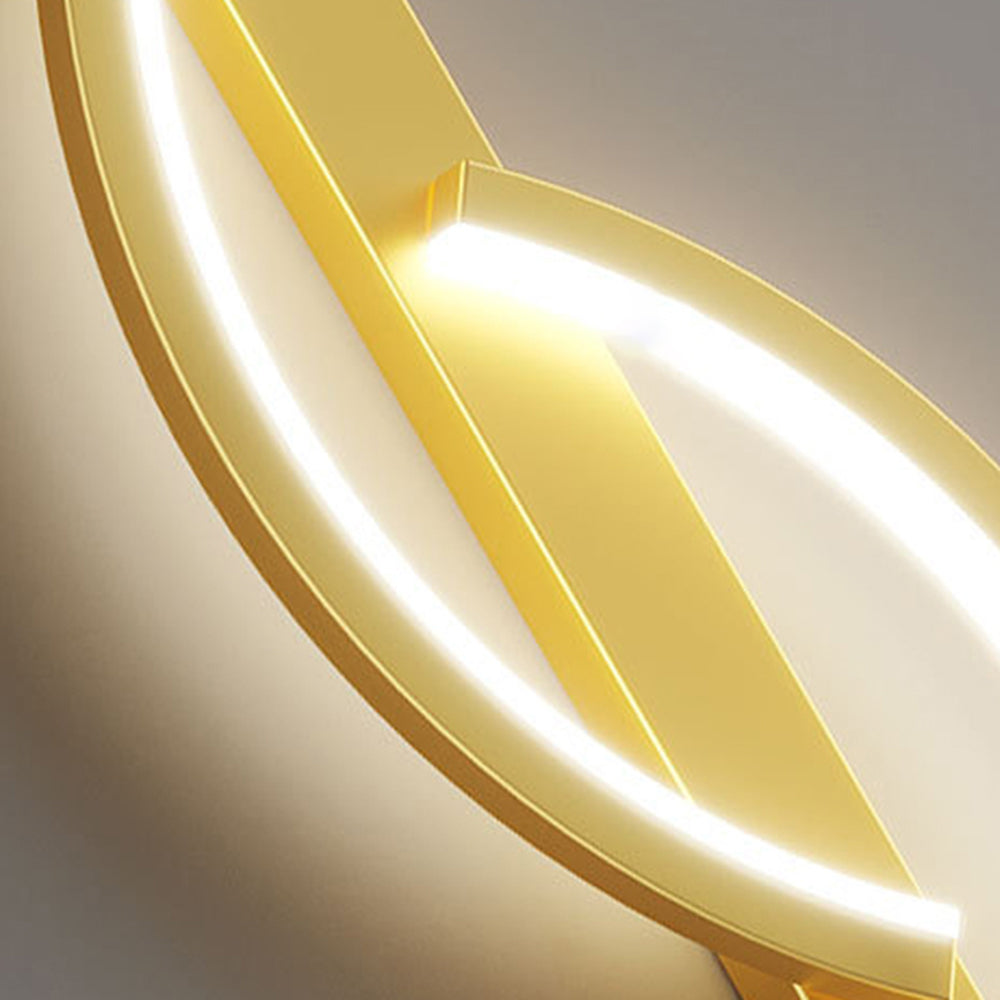 Close-up of gold curved strips and bright diffuser faces attached to the gold rectangular backplate