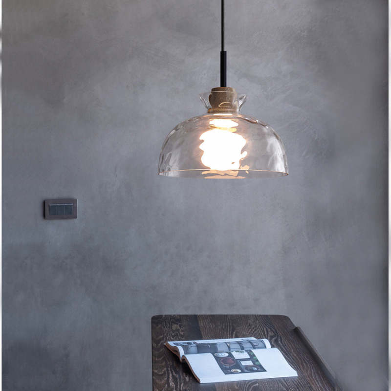 Single rounded dome glass pendant over small table