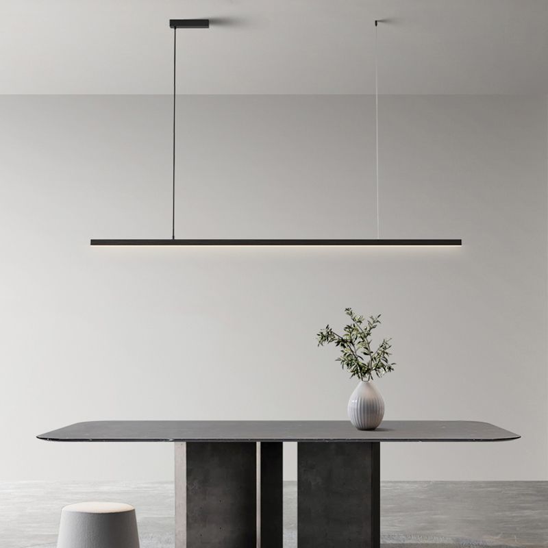 Black Edge bar on two suspension points above grey dining table with white vase, branches and stools