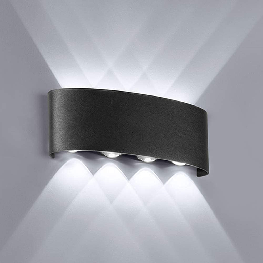 Black curved wall light with a central round lens casting cool-looking upward and downward beams