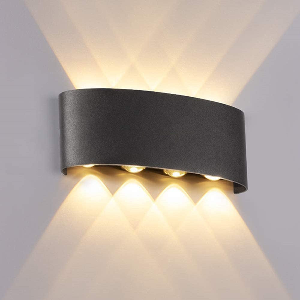 Black curved wall light without a front round lens casting warm-looking upward and downward beams