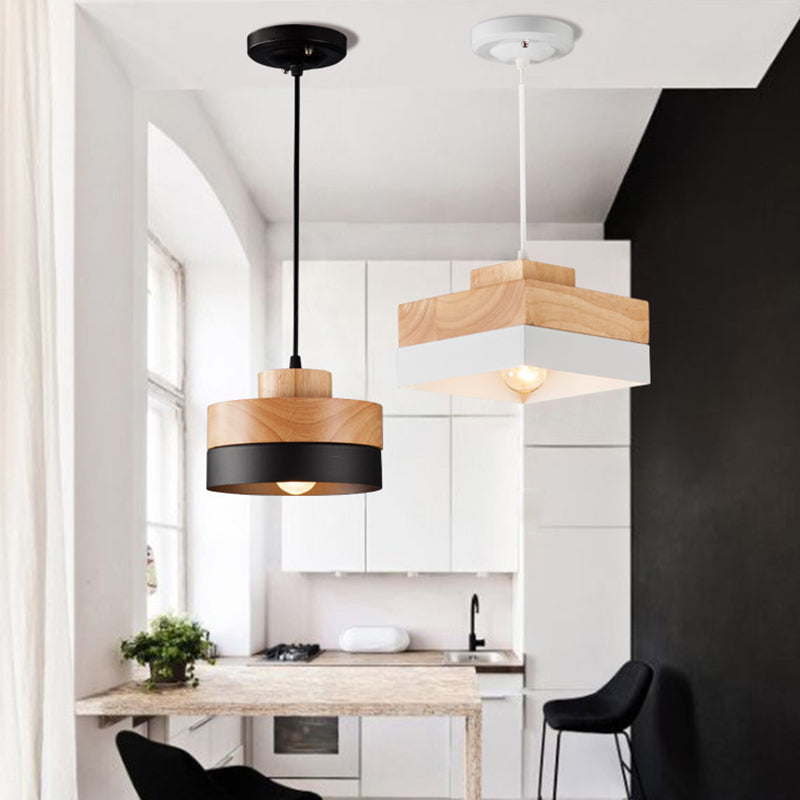Black round and white square Morandi pendants above a dining table