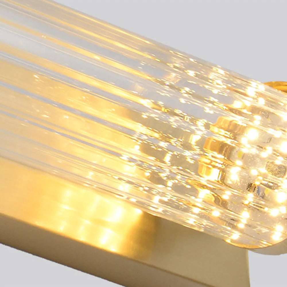 Closeup of Kristy clear longitudinal flutes beside a gold-tone end cap with warm reflections