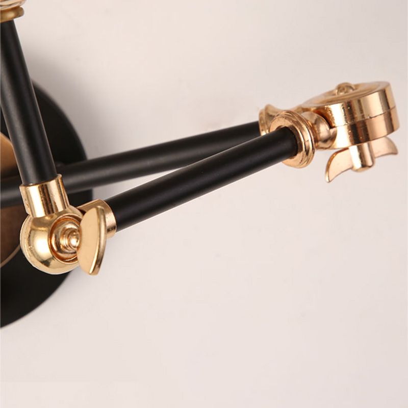 Close-up of black Carins arm sections and gold adjustable joints.