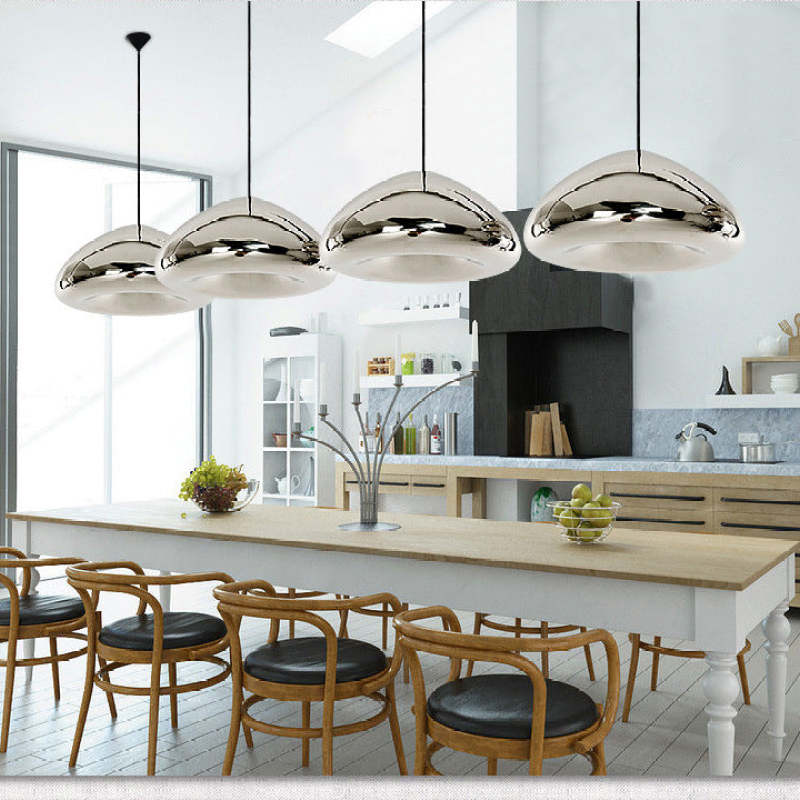 Silver rounded pendant lights above a kitchen island