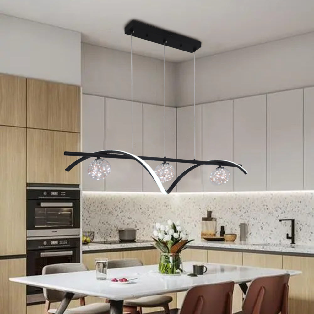 Black three-globe light above a kitchen island