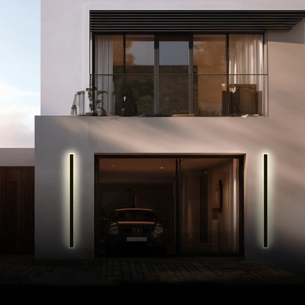 Two tall illuminated Edge wall lights flanking an open garage