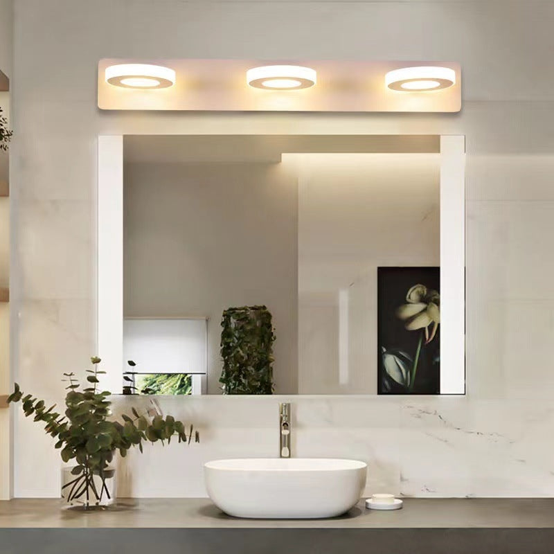 Leigh three-disc wall light above a basin and mirror