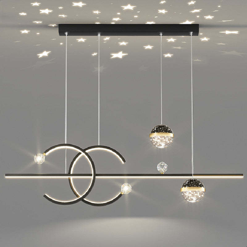 Lit dark-frame Madina curved bar and globe shades beneath a ceiling with a pictured star pattern