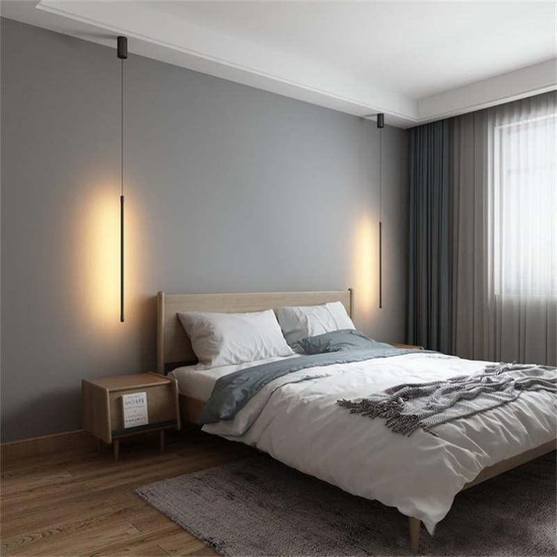 Two Edge black rod pendants placed on opposite sides of a bed in a grey bedroom
