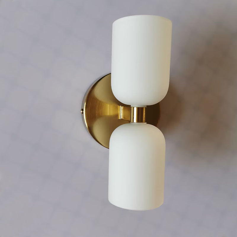 Close-up of the gold-colored plate and paired glass cylinders