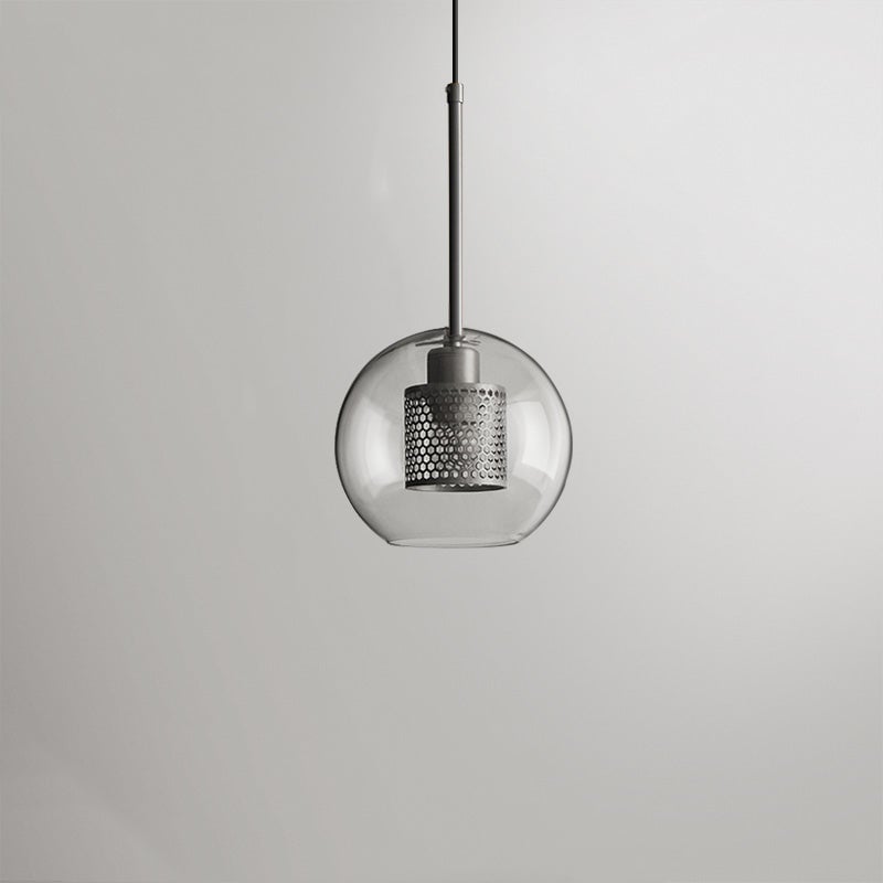 Silver Oneal A compact round glass pendant with a perforated metal cylinder and matching stem