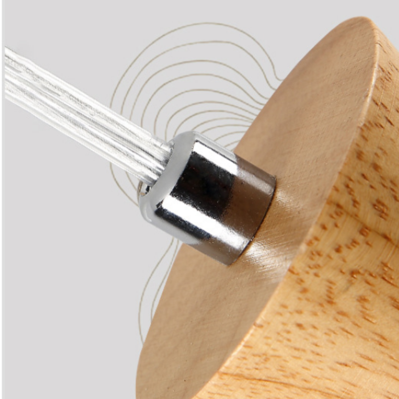 Close-up of a clear-looking cable entering a shiny Silver-toned fitting on a round light wooden canopy
