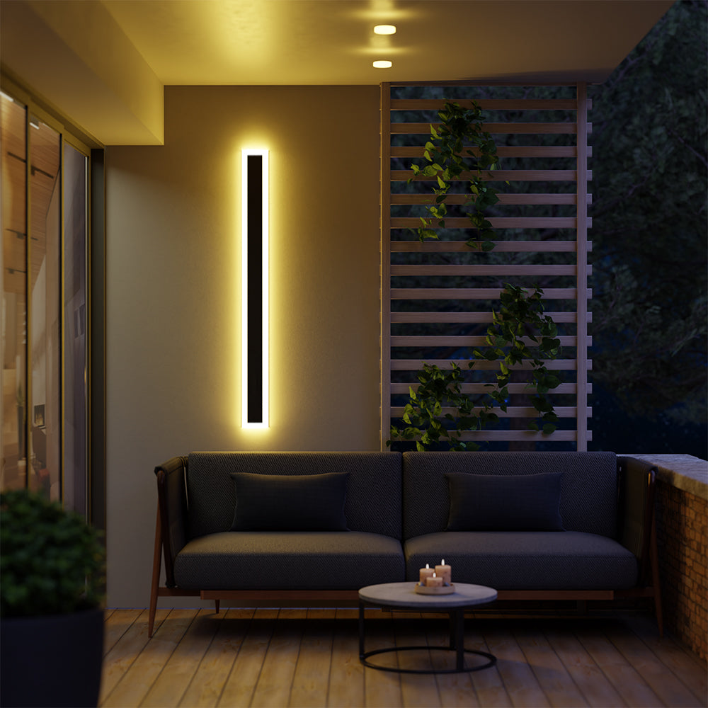 Single glowing Edge wall light above a sofa on a covered wooden patio