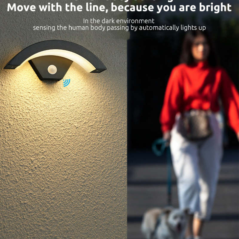 Sensor wall light beside a person walking outside