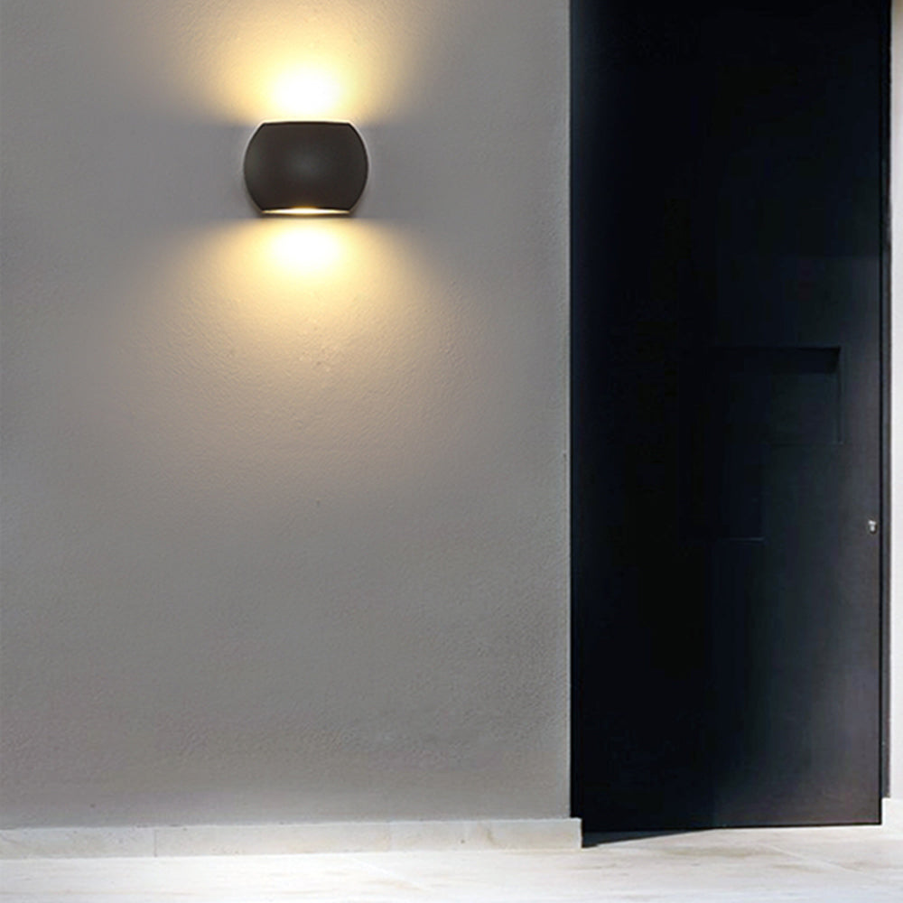 Black Style B Orr wall lamp lit beside an open black door