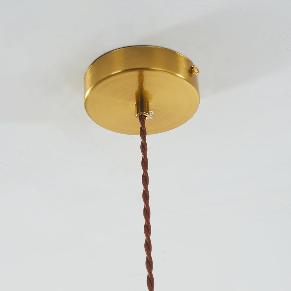 Close round gold-tone ceiling canopy, side fasteners, central cord grip and braided brown suspension cord