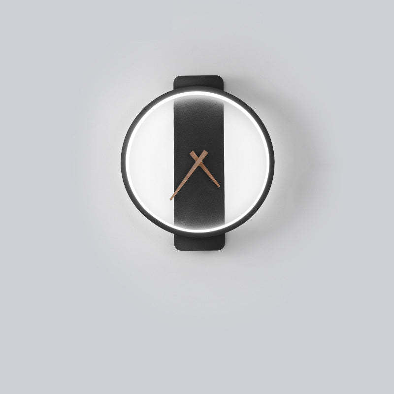 Black round clock-face wall light with bright White inner illumination and a vertical backplate on a Gray wall