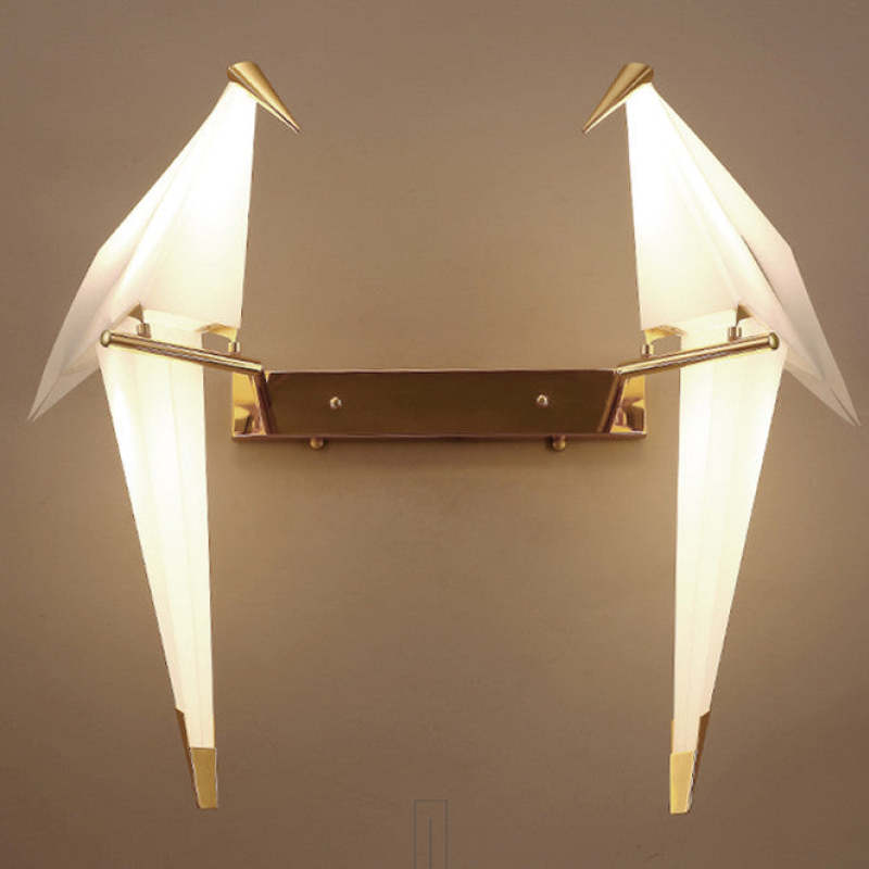 Front view of two illuminated Clifford birds on one rectangular gold-tone wall plate with horizontal arms
