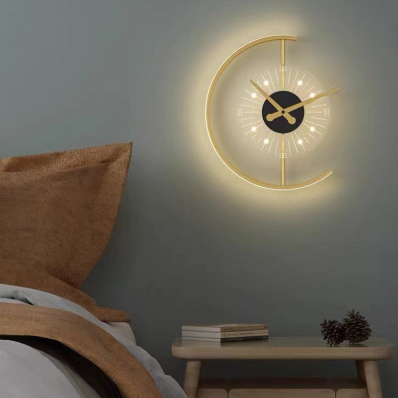 Nielsen clock wall light on a grey wall above a wooden bedside table with books and pinecones