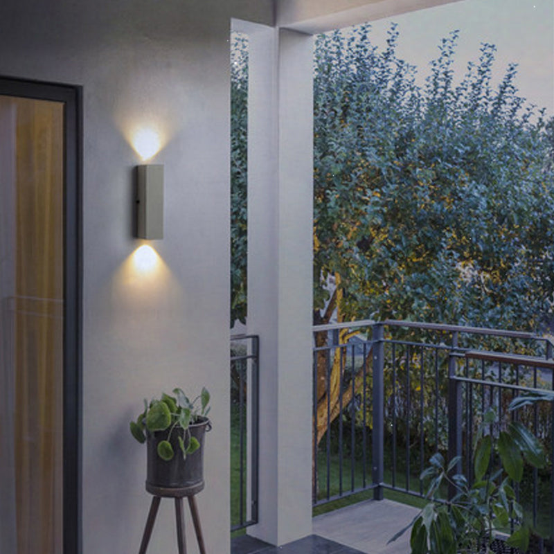 Cement up-and-down light on an outdoor corridor wall