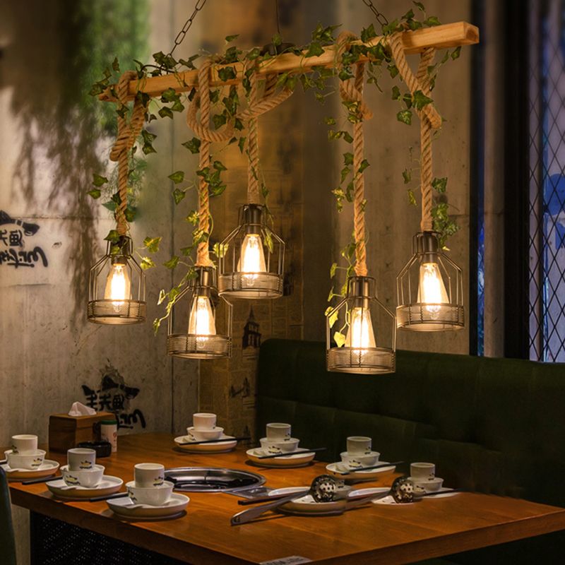 Five illuminated Alessio cage lamps above a restaurant dining table.
