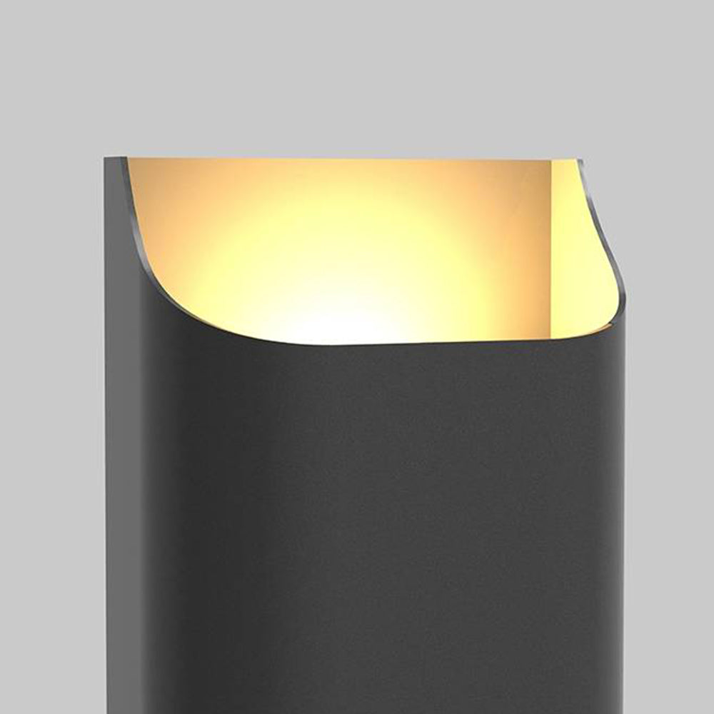 Close-up of the upper opening of a tall black Orr wall light