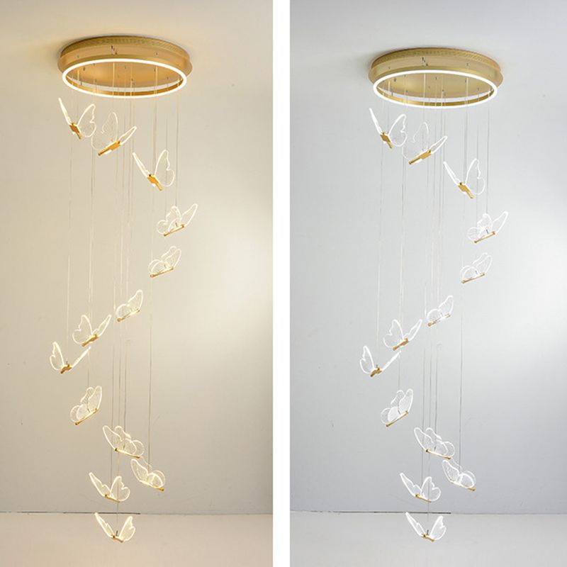 Side-by-side long Olivia butterfly cascades on pale wall, with luminous gold-tone round canopies