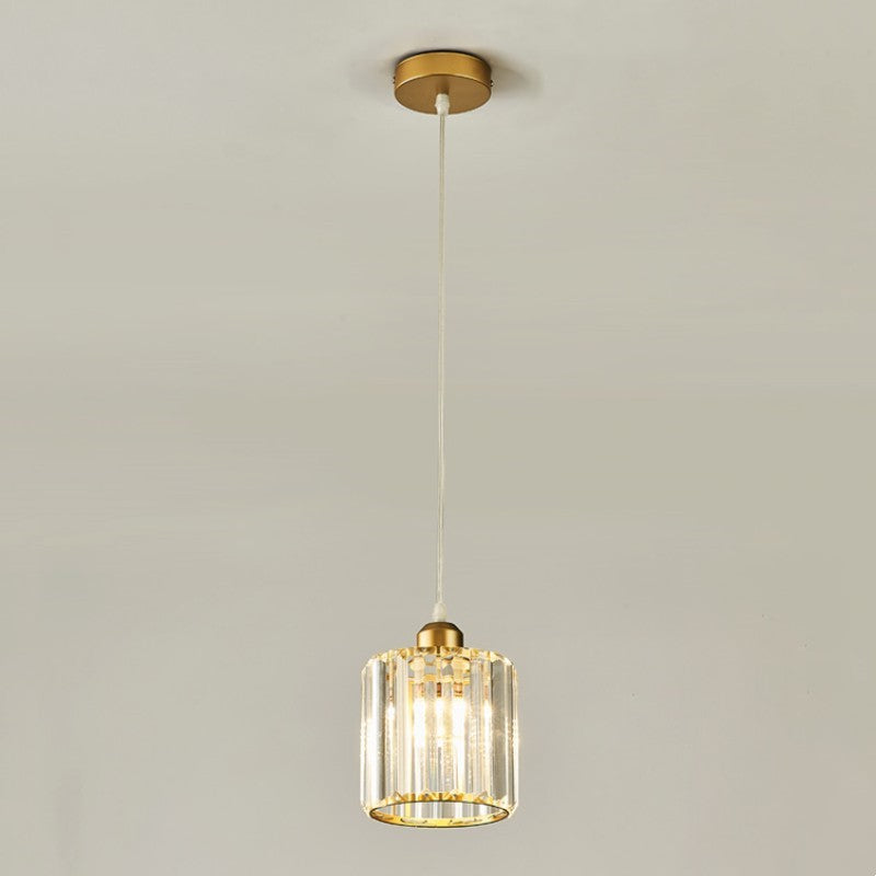 Single gold Herbert cylindrical glass pendant with a small round canopy against a pale background