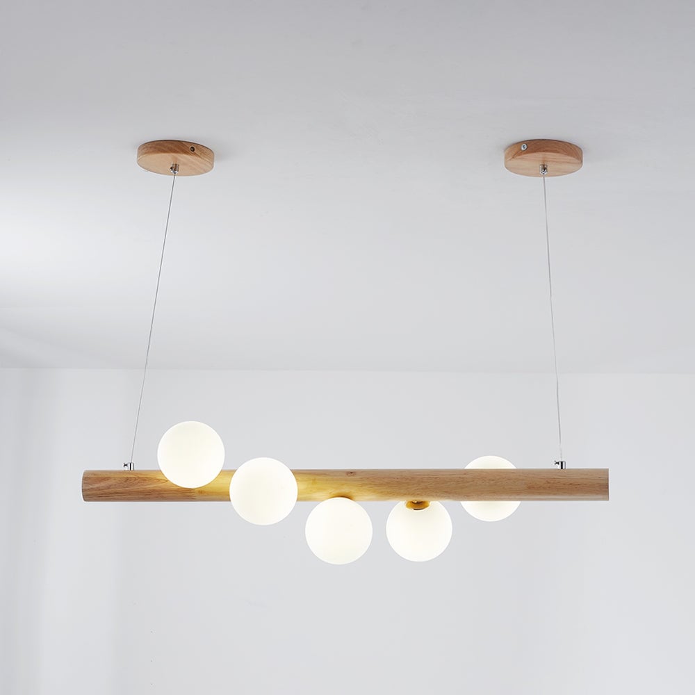 Light wood five-globe pendant with two separate round canopies and thin wires in a White interior