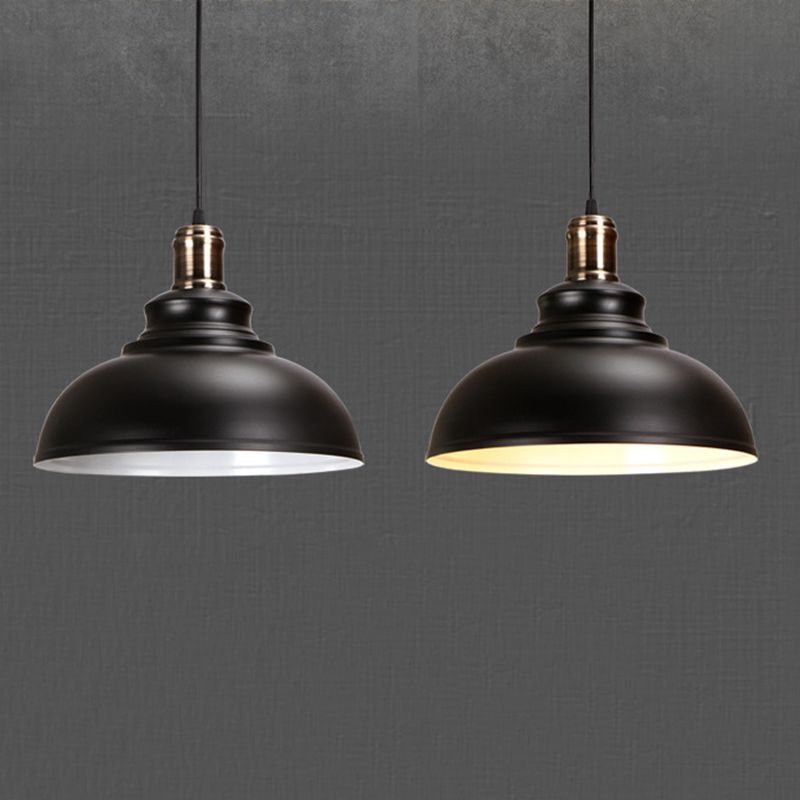 Two black Cooley domes with metallic upper fittings, showing pale and warmly illuminated interiors