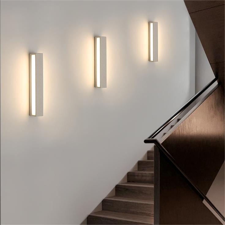 Pale vertical Edge wall lights beside an indoor staircase