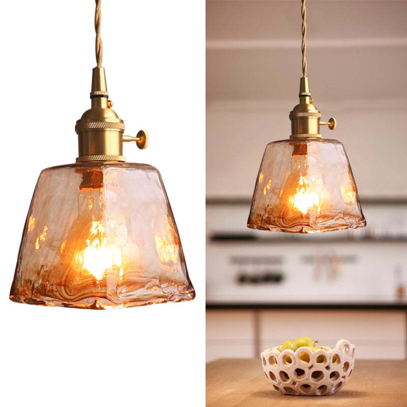 Two-panel view of an amber glass pendant isolated and above a kitchen counter with a fruit bowl
