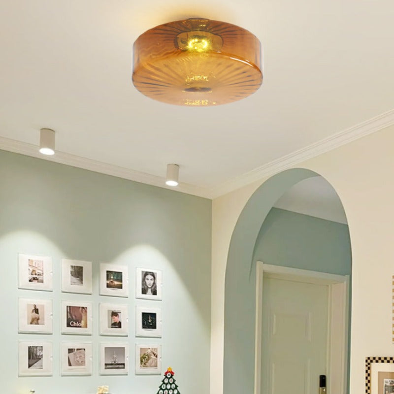 Hailie round brown glass ceiling light in a pale room