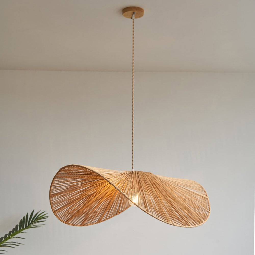 Large brown Muto wavy twine shade beneath woodgrain-look round canopy, with twisted cord and plant leaf at lower left