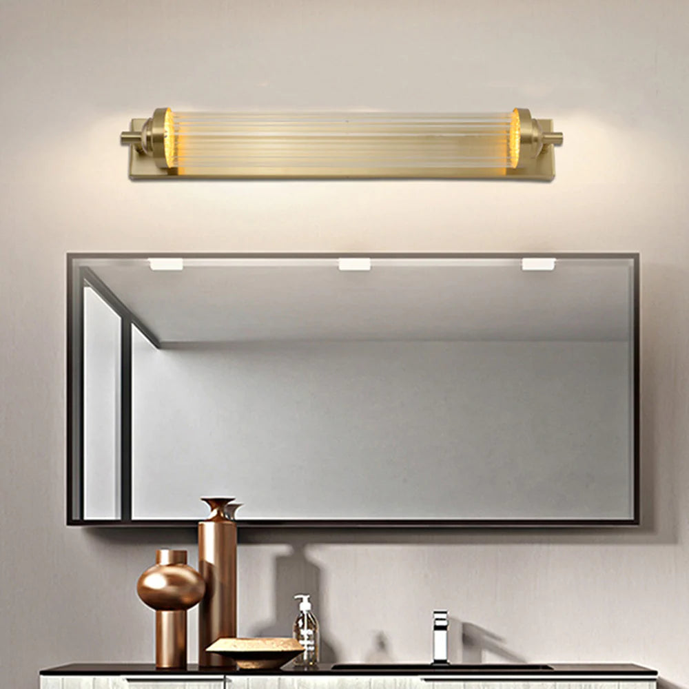 Kristy fluted tubular fitting above a grey mirror with metallic vases and tap below