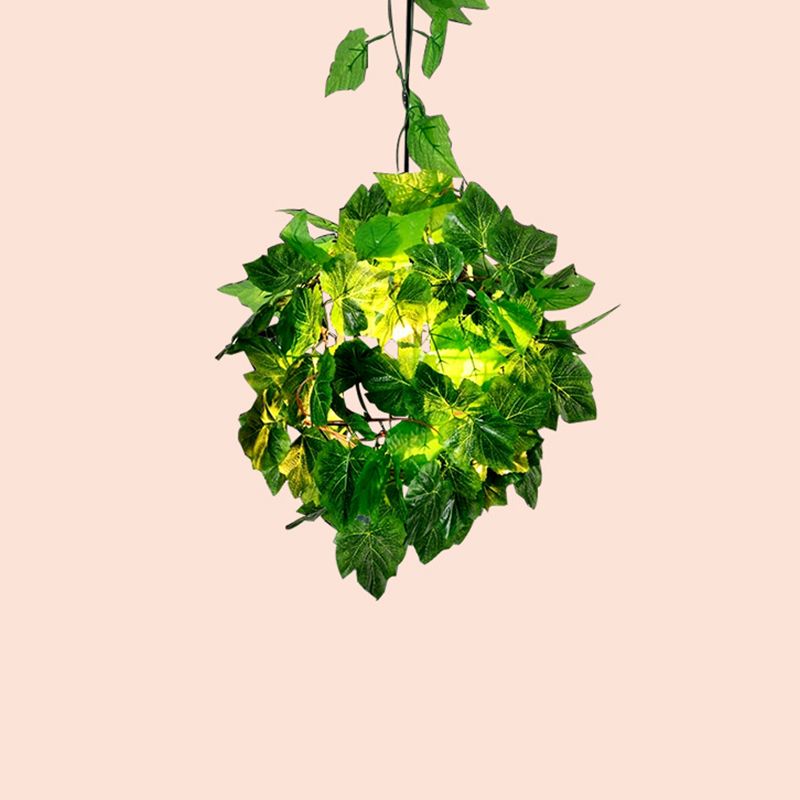 Green Nest pendant with dense leafy decoration around the spherical cage.