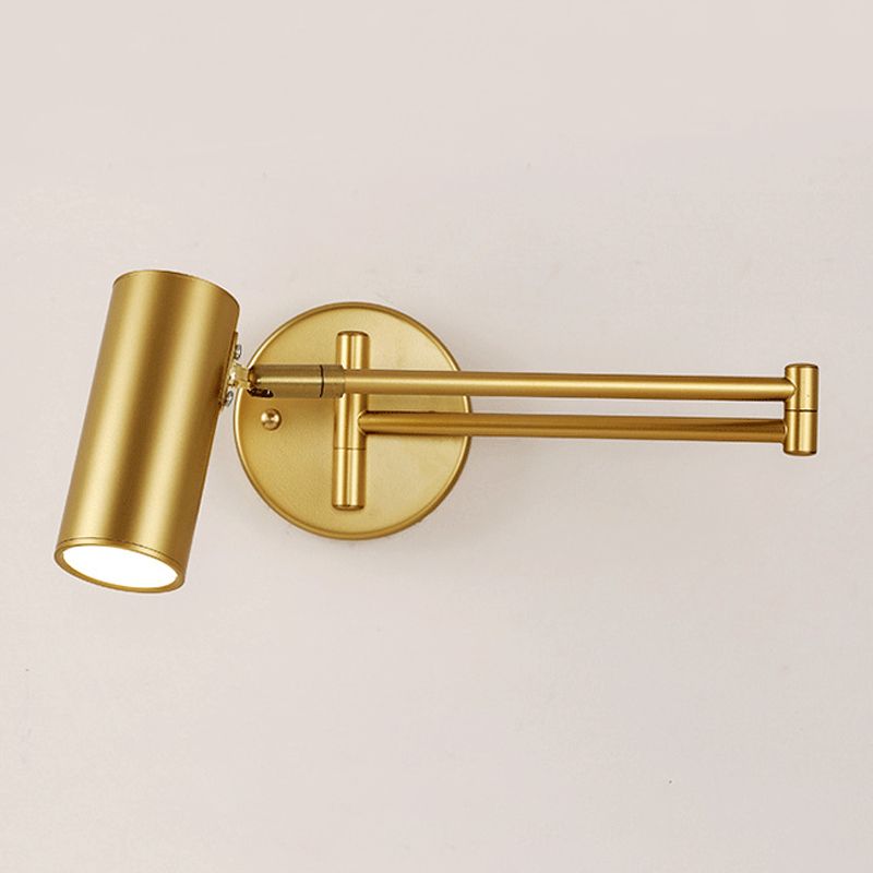Brady Gold tilted cylindrical shade with pale opening, folded arms and round wall plate