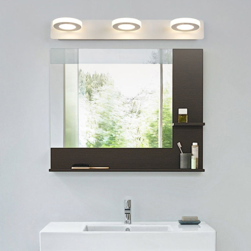 White Leigh circular light sections over a bathroom mirror cabinet