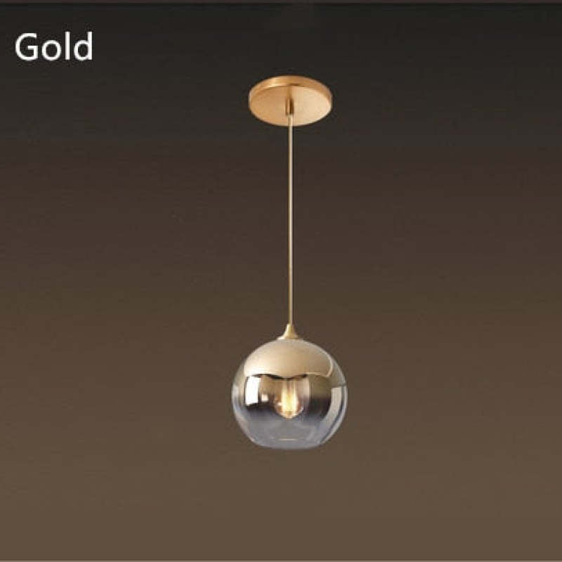 Gold-labeled gradient globe pendant with a gold-tone canopy against brown